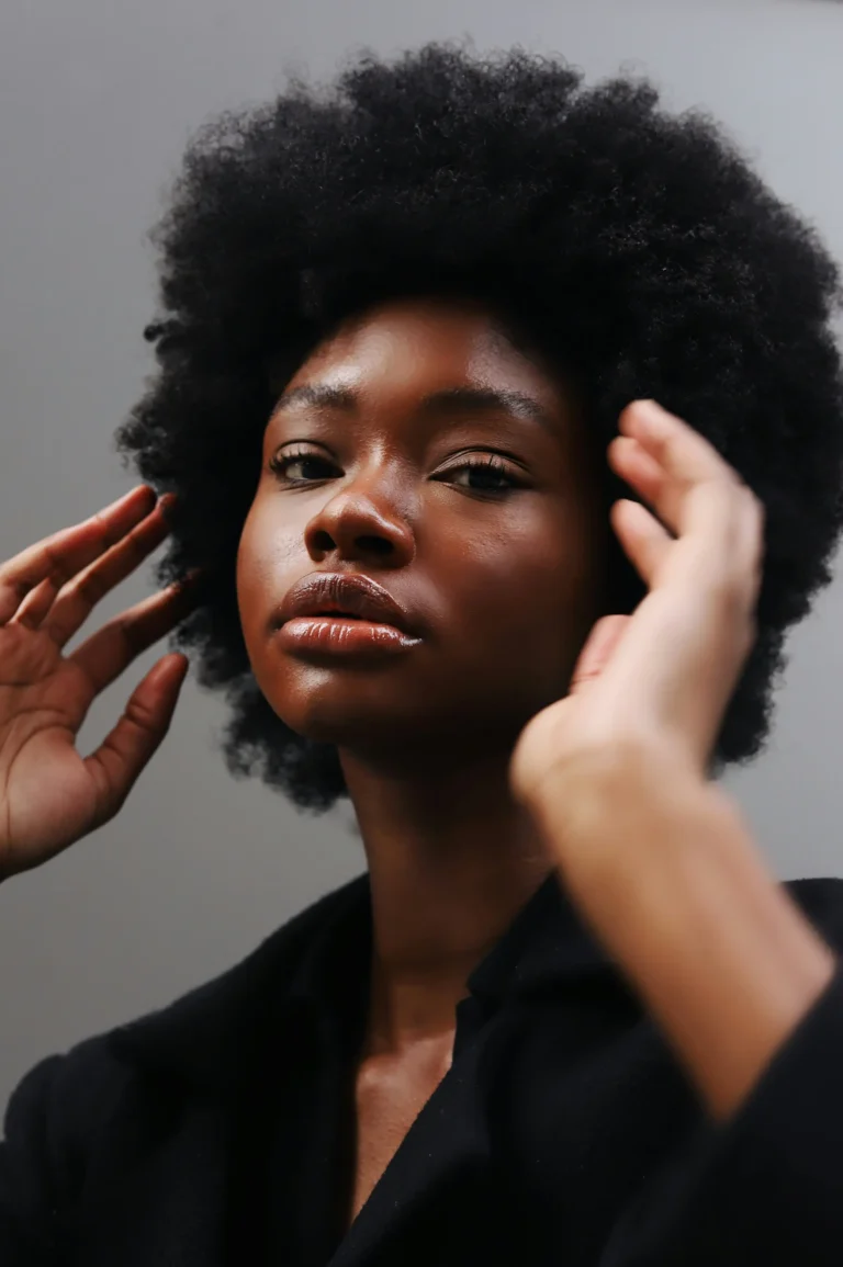 Mulher negra com cabelo afro e aparência natural em retrato de beleza